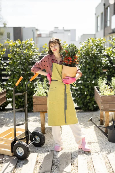 Portrait Young Cheerful Gardener Green Apron Holding Pot Flower Home — Photo