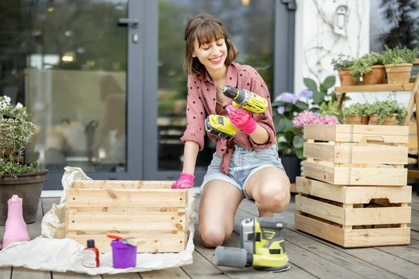 Young Cheerful Housewife Makes Wooden Boxes Twisting Them Screwdriver While — Fotografia de Stock