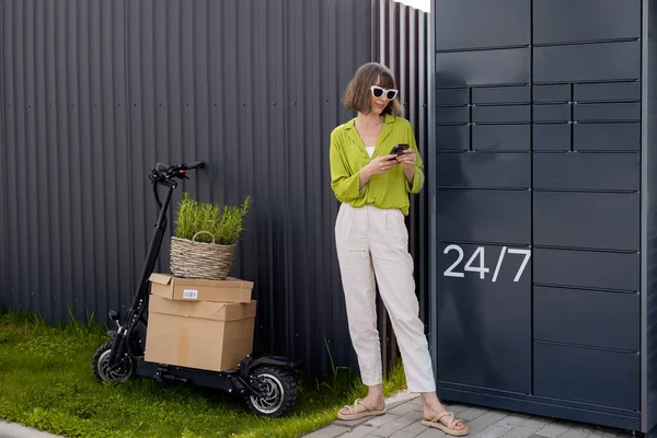 Young Woman Standing Phone Automatic Post Terminal Delivering Goods Electrical — стоковое фото