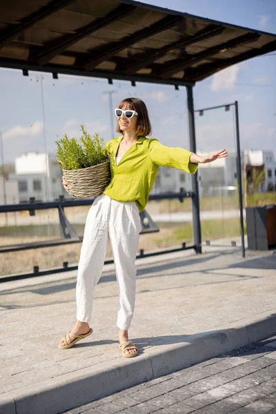 Young Woman Stands Flowerpot Bus Stop Waiting Public Transportation Concept — 图库照片