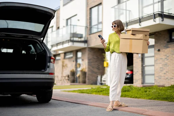 Young Woman Using Phone While Going Home Parcels Vehicle Open — Stockfoto