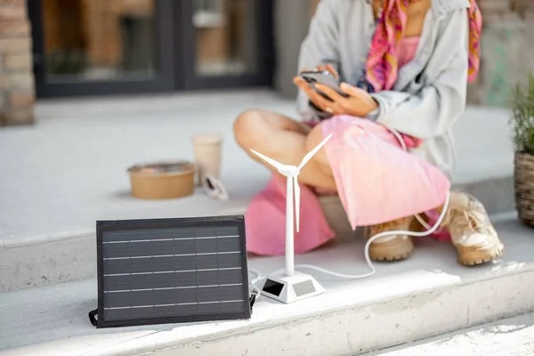 Person Use Smart Phone Charge Portable Solar Panel While Sitting — ストック写真