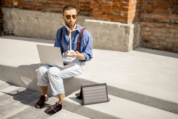 Stylish Man Works Laptop Charge Portable Solar Panel While Sitting – stockfoto