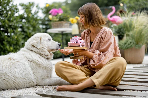 Cheerful Woman Playing Her Adorable White Dog While Sitting Festive — Zdjęcie stockowe