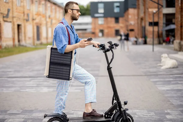 Stylish Guy Going Drive Electric Scooter Solar Panel His Bag stockbilde