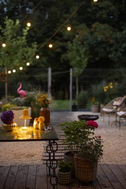 Beautiful atmospheric backyard with lights at dusk
