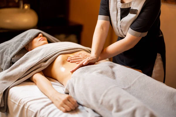 Masseuse Performs Professional Abdominal Massage Female Client Covered Towels Couch — Stock Photo, Image