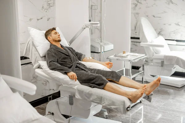 Man Bathrobe Lying Medical Couch Blood Wash Procedure Catheter His — Stok fotoğraf
