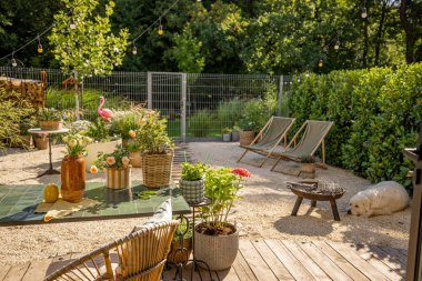 Beautifully landscaped tiny back yard with flowers and plants of country house on nature