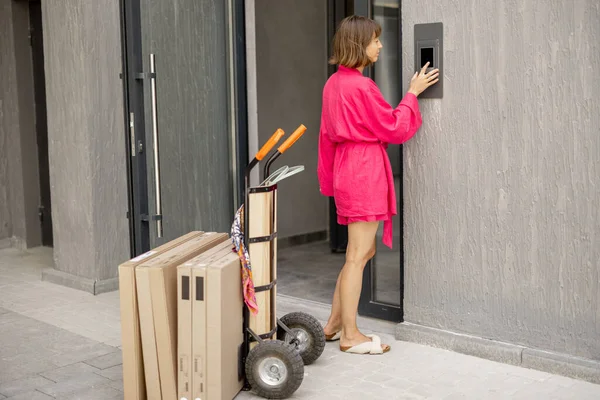Woman Calls Intercom Standing Parcels Entrance Apartment Building Concept Delivering — стоковое фото