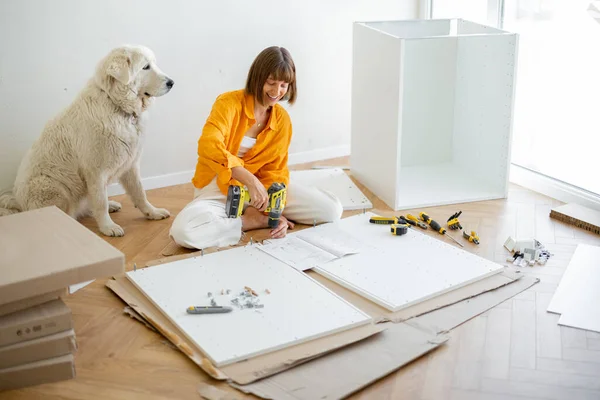 Young Woman Assembles Furniture Herself Sitting Having Fun Her Cute — Stockfoto