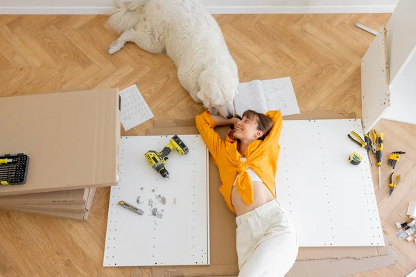 Young Woman Lies Floor Her Cute Dog Resting While Making — Stockfoto
