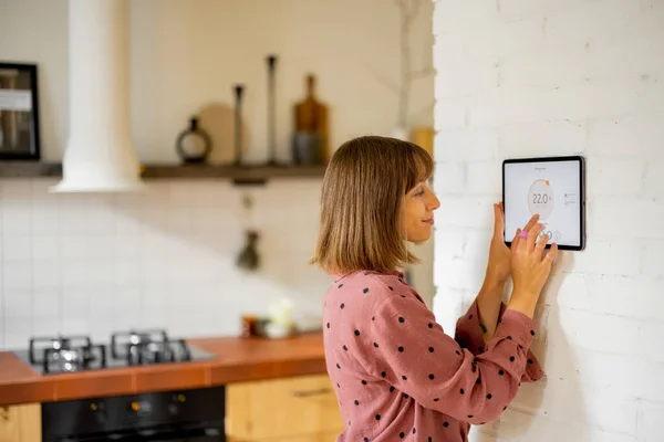 Woman Controls Room Temperature Digital Panel Mounted Wall Kitchen Concept — Φωτογραφία Αρχείου