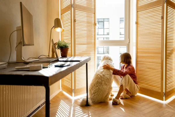 Young Woman Sits Her Dog Window Blinds Looks Away Cozy — Stok fotoğraf