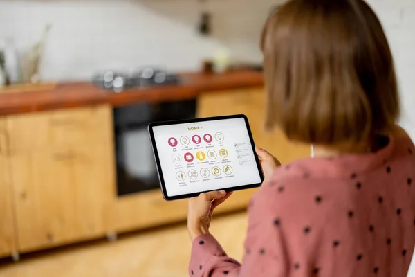Woman Holds Digital Tablet Running Mobile Application Smart Home Standing — Zdjęcie stockowe