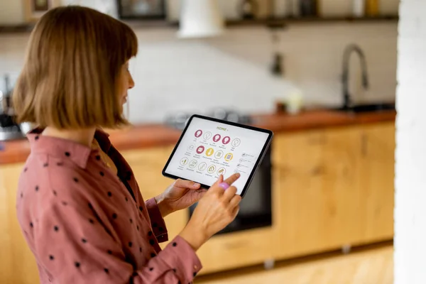 Woman Holds Digital Tablet Running Mobile Application Smart Home Standing — ストック写真