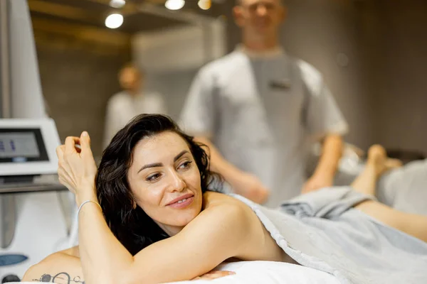 Portrait Happy Adult Woman Lying Medical Couch Vacuum Roller Massage — Foto de Stock