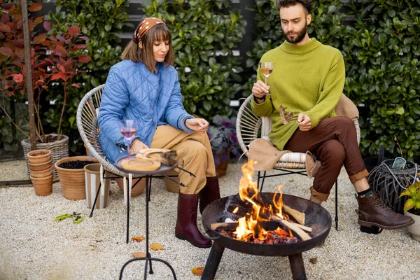 Young Stylish Couple Grilling Food Warming While Sitting Together Fire — Stock Photo, Image