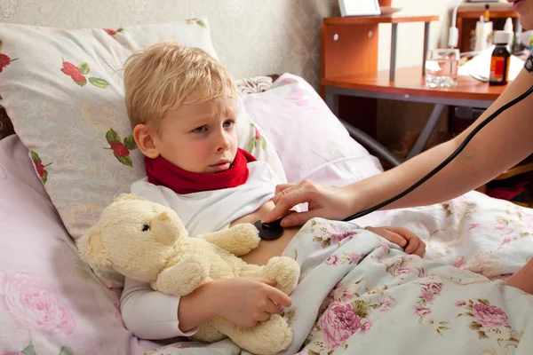 Sick boy lies in bed — Stock Photo, Image