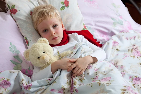 Sick boy lies in bed — Stock Photo, Image