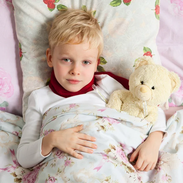 Sick boy is in bed — Stock Photo, Image