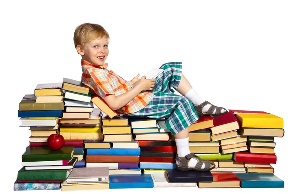 Little boy on a pile of books — Stock Photo, Image