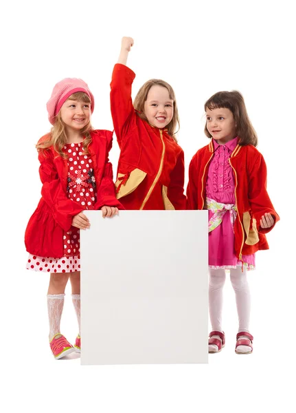 Girls in red are holding white billboard — Stock Photo, Image