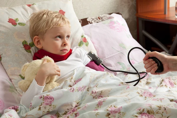 Sick boy is laeing in bed — Stock Photo, Image
