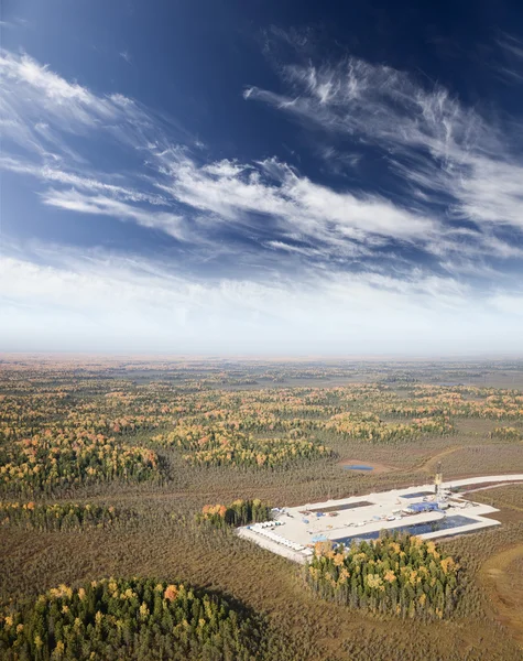 Oil field in forest plain in autumn — Stock Photo, Image