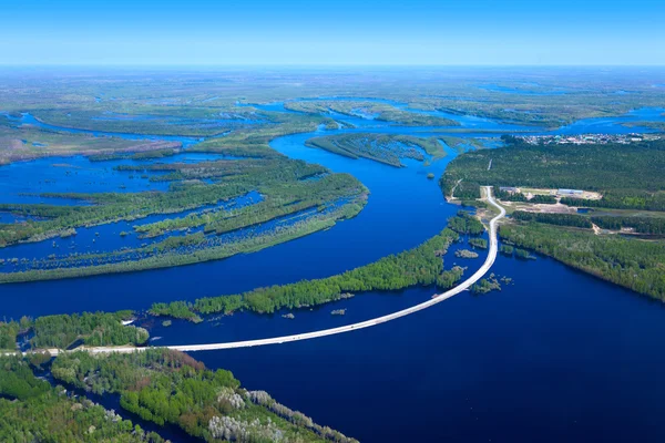 Aerial view flooded forest plains and road crossing it — Stock Photo, Image