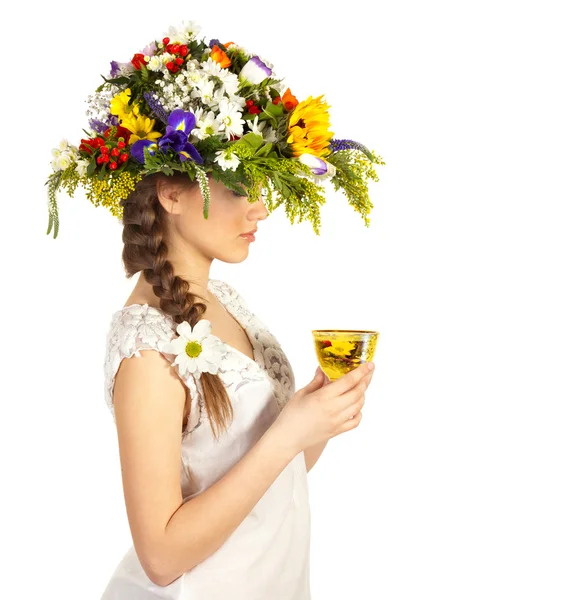 Beautiful girl in hat of flowers and cup of tea — Stock Photo, Image
