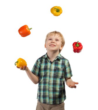 Little boy juggles some fruits and vegetables clipart