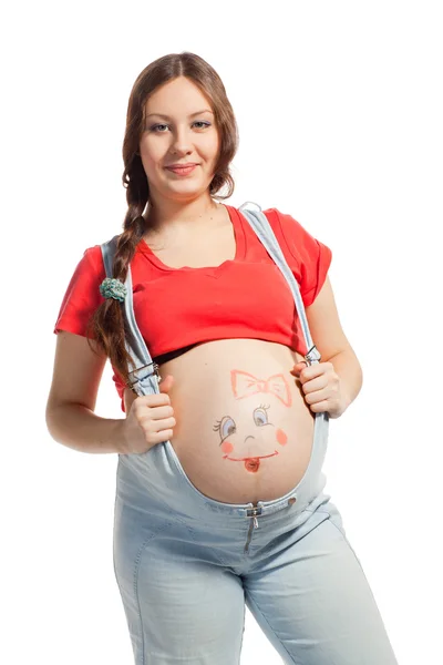 Pregnant woman with funny drowing on the her belly — Stock Photo, Image