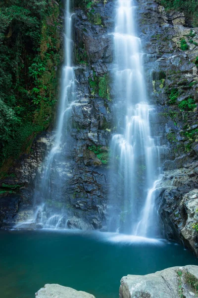 waterfall flowing streams falling from mountain with calm blurred water surface long exposure shot image is taken at thangsning fall shillong meghalaya india.