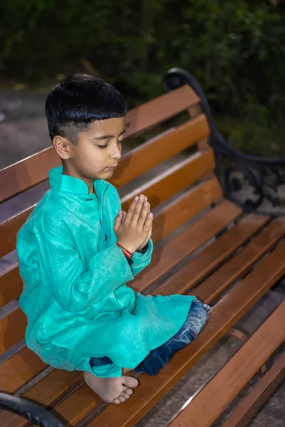 Young Kid Meditating Wood Bench Traditional Dress Evening Different Angles — 스톡 사진