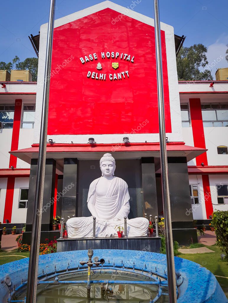 military hospital building with isolated white buddha statue at day