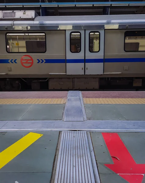 isolated train standing at vacant metro station at day from flat angle image is taken at delhi metro station new delhi india on Apr 10 2022.