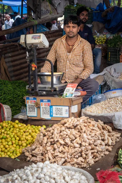 vegetable seller selling vegetables at local market from flat angle image is taken at delhi vegetable market india on Jun 17 2022.