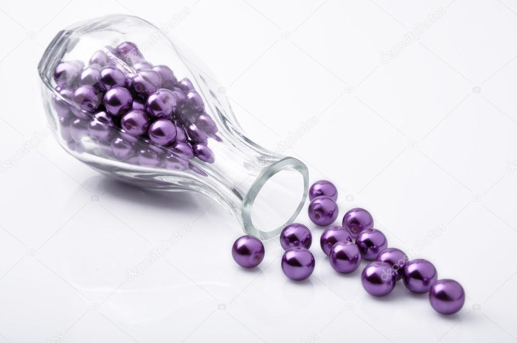 Purple beadl in the glass bottle