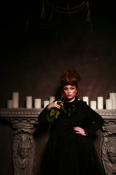 빨간 장미와 함께 촛불 근처에 서 고딕 소녀 — 스톡 사진