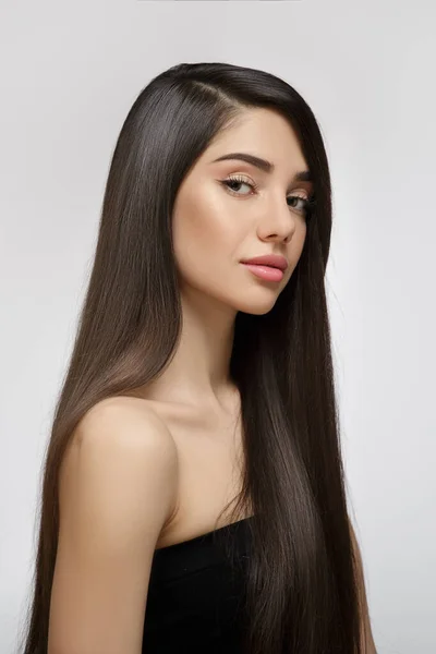 Fashion woman with straight long shiny hair. Beauty and hair care