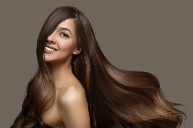 Portrait of a beautiful brunette woman with long wavy hair. Copycpase clipart