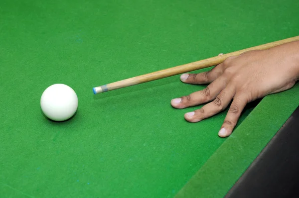 Snooker player with billiard cue ready to hit white ball with selective focus — Stock Photo, Image