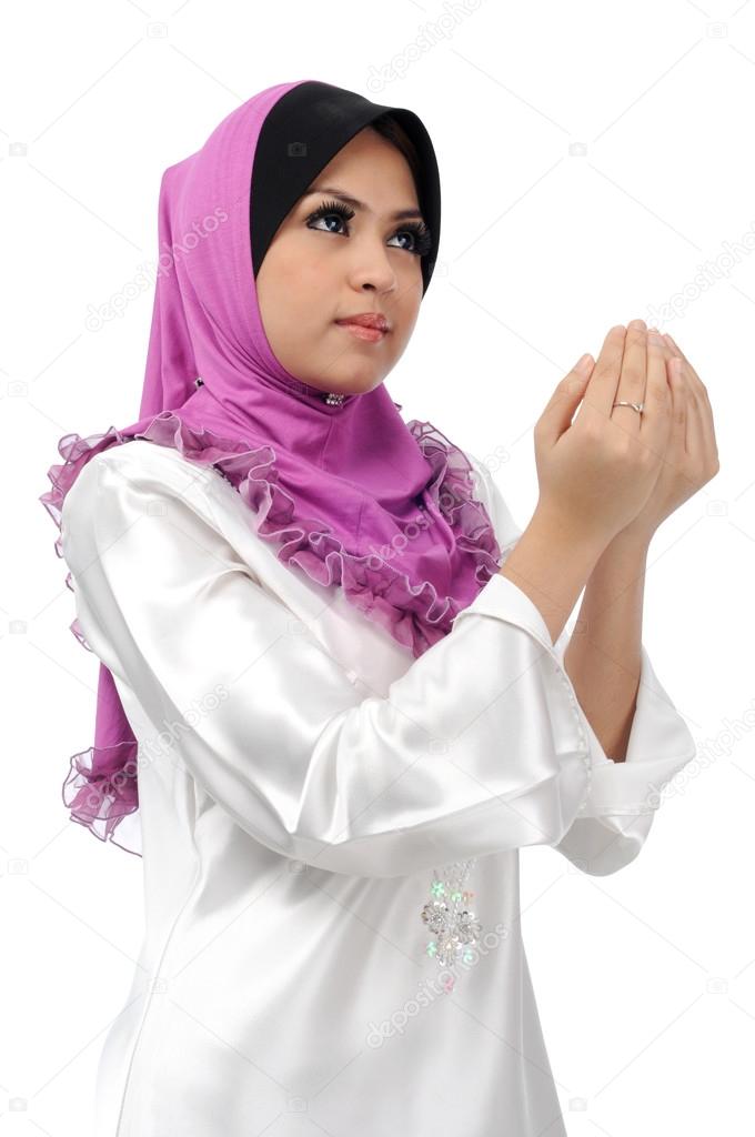Beautiful young muslim woman pray isolated on white background
