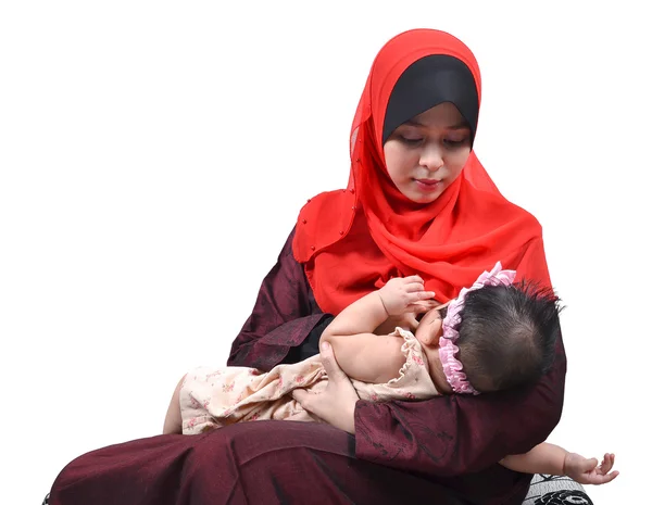 若いアジアのイスラム教徒の母親の母乳白い背景上に分離されて彼女のかわいい赤ちゃんの少女 ストック画像
