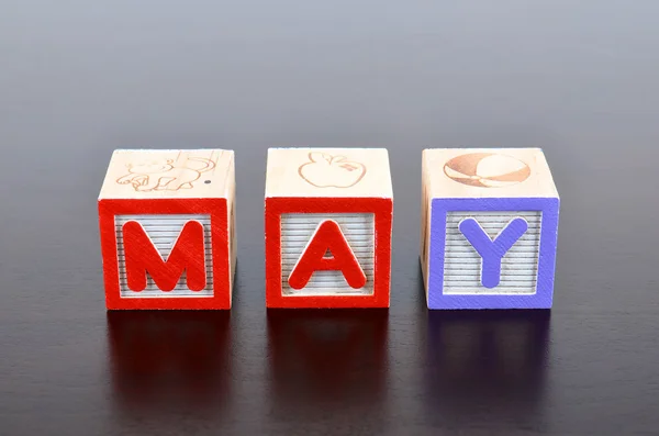 May word formed by wood alphabet blocks — Stock Photo, Image