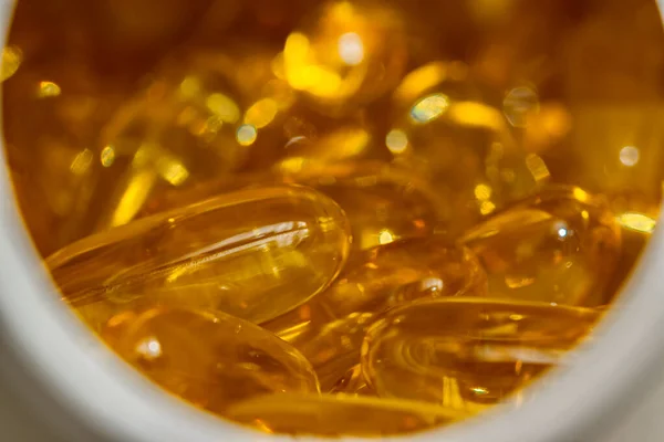 Yumuşak altın renkli sağlıklı Omega-3 diyet ilavesinin fotoğrafı.