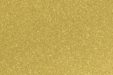 Beautiful glowing gold colored glitter background.