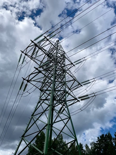 Photo of electrical network against the cloudy sky background.