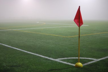 Sisin içinde bir futbol sahası üzerinde kırmızı köşe bayrak görüntüsü